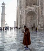 A monk texting at the Taj...